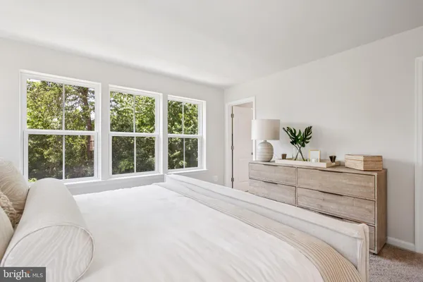 a bedroom with a large bed and a large window