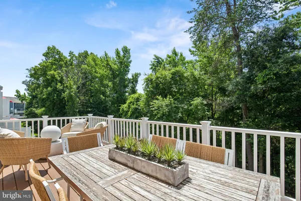 a view of a wooden chairs and table on the deck