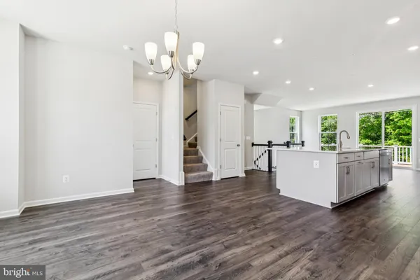 a view of a room with wooden floor and large windows