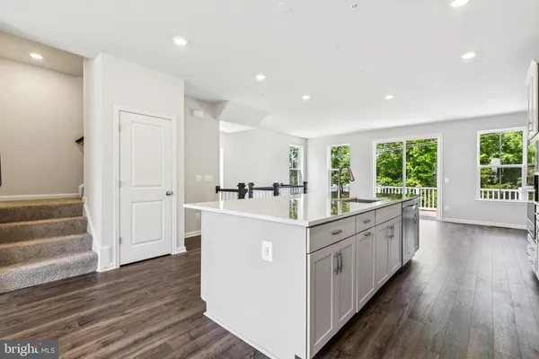 a kitchen with sink and wooden floor