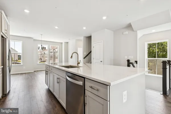 a kitchen with sink and refrigerator