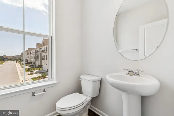 a bathroom with a sink a mirror and a toilet