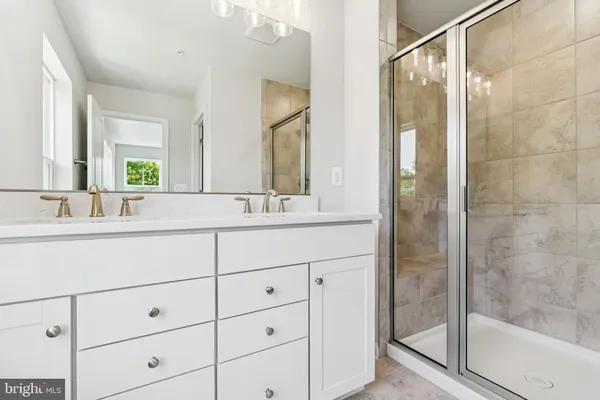a bathroom with a shower sink and mirror