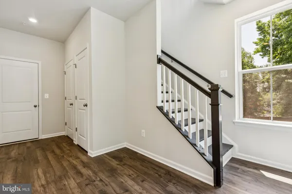 a view of an entryway with wooden floor and door