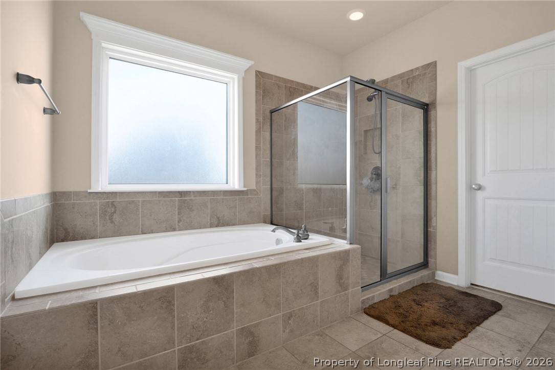2145 Harrington Road Fayetteville, NC 28306 - Photo 32 of 50 a bathroom with a tub and a shower