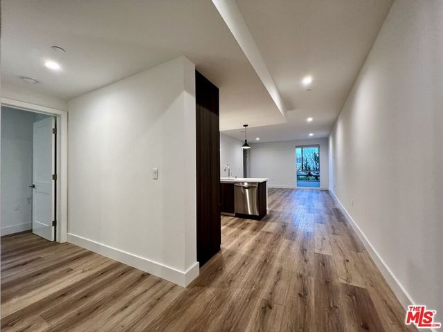 a kitchen with stainless steel appliances granite countertop a refrigerator a sink a stove and microwave