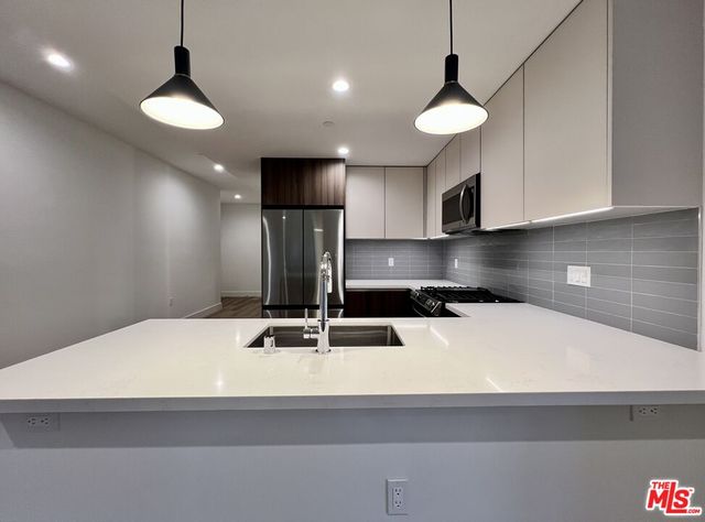 a bathroom with a double vanity sink toilet and shower