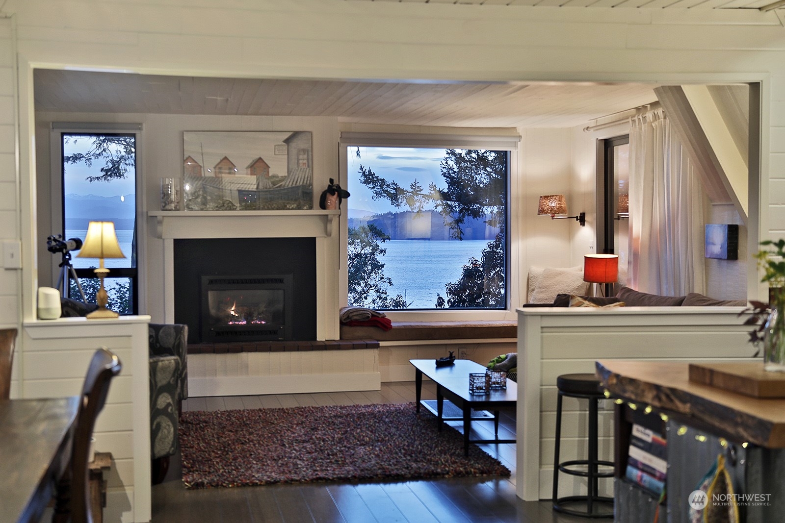 6828 Sills Road Clinton, WA 98236 - Photo 12 of 40 a living room with furniture and a fireplace