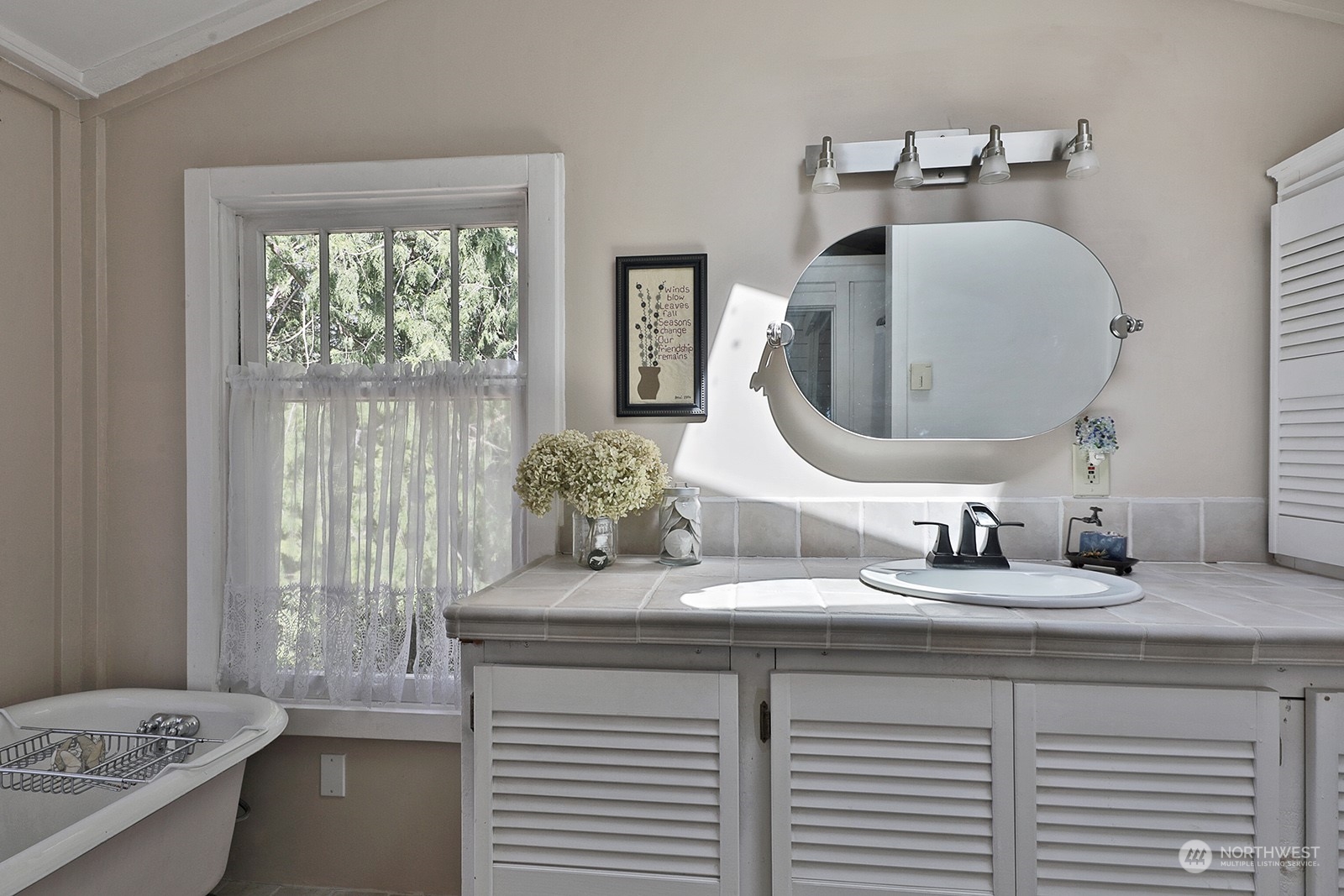 6828 Sills Road Clinton, WA 98236 - Photo 24 of 40 a bathroom with a double vanity sink and a mirror