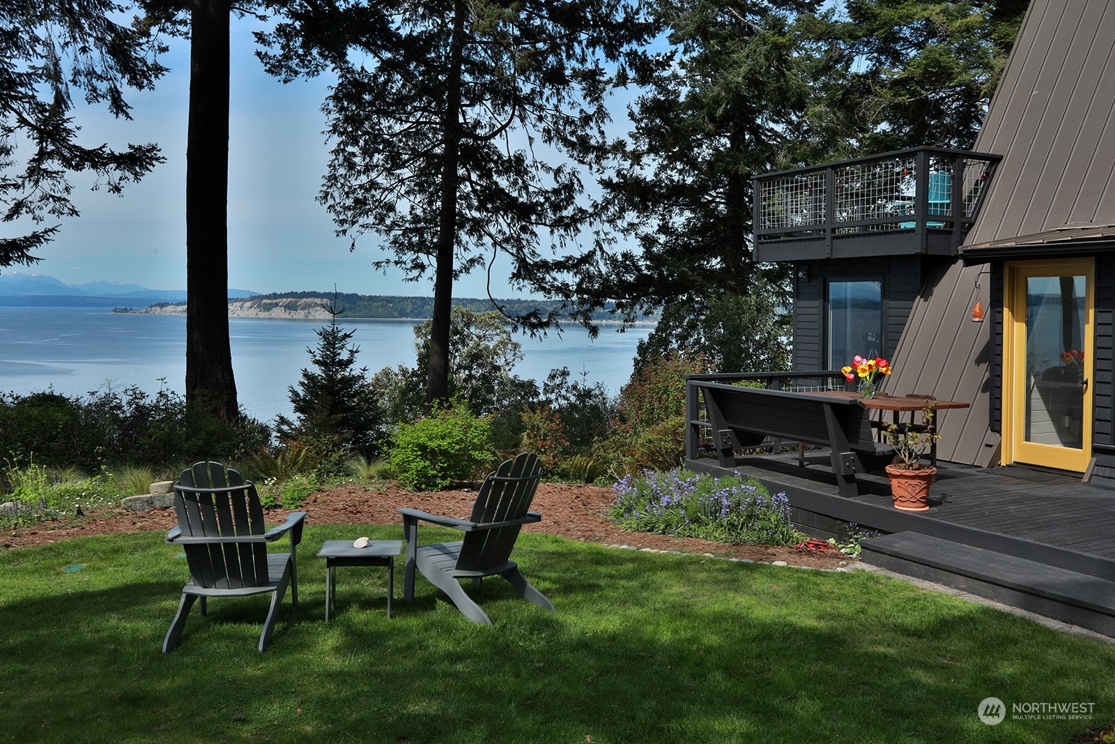 6828 Sills Road Clinton, WA 98236 - Photo 3 of 40 a view of a chairs and table in a patio