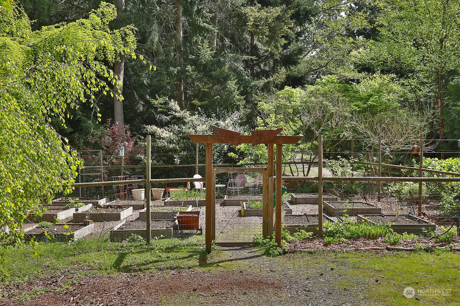 6828 Sills Road Clinton, WA 98236 - Photo 34 of 40 a backyard of a house with lots of green space and fountain