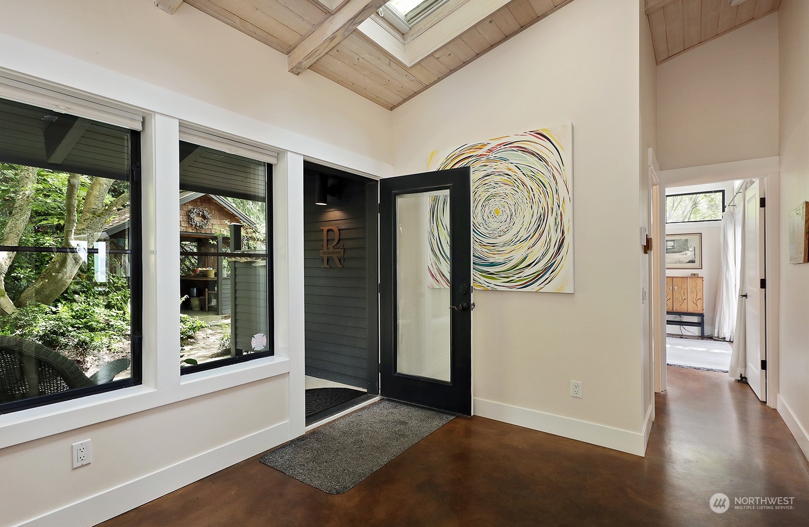 6828 Sills Road Clinton, WA 98236 - Photo 9 of 40 a view of an entryway with wooden floor and door
