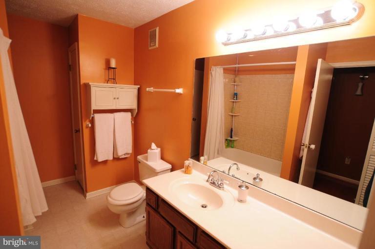 2297 Hunter's Run Drive, Unit 2297 Reston, VA 20191 - Photo 7 of 17 a bathroom with a sink toilet and shower