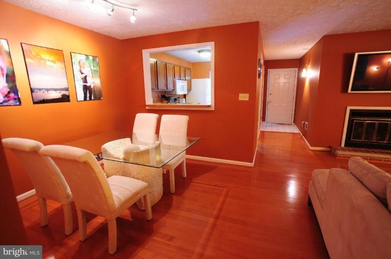2297 Hunter's Run Drive, Unit 2297 Reston, VA 20191 - Photo 8 of 17 a living room with furniture and a flat screen tv