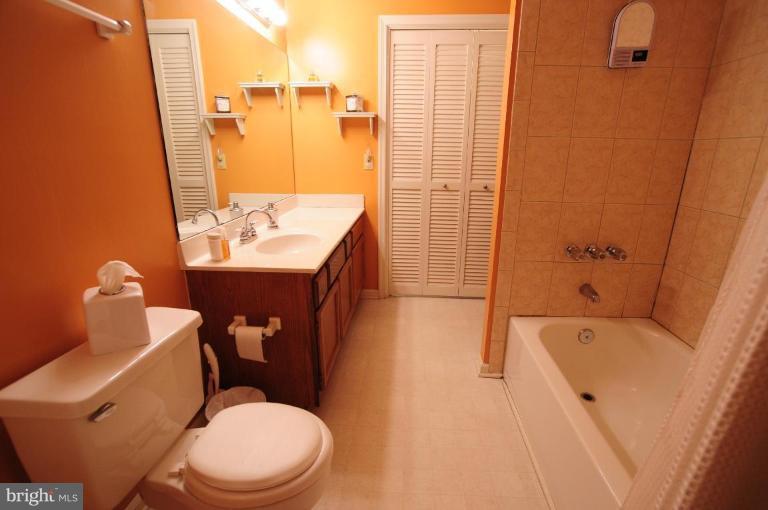 2297 Hunter's Run Drive, Unit 2297 Reston, VA 20191 - Photo 9 of 17 a bathroom with a sink toilet and shower