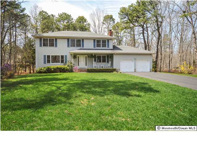 148 Sams Road Jackson, NJ 08527 - Photo 1 of 18 a black and white house with a big yard and large trees