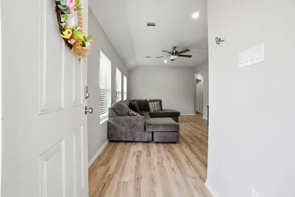 a living room with furniture and flowers