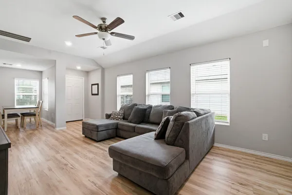 a living room with furniture and wooden floor