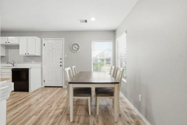 a view of a dining room with furniture and wooden floor