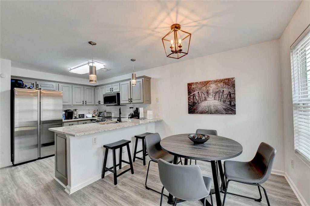 526 Terrapin Lane Winder, GA 30680 - Photo 11 of 40 a view of a dining room with furniture a chandelier and wooden floor