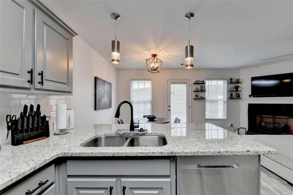 526 Terrapin Lane Winder, GA 30680 - Photo 15 of 40 a kitchen with kitchen island granite countertop a sink stainless steel appliances and cabinets