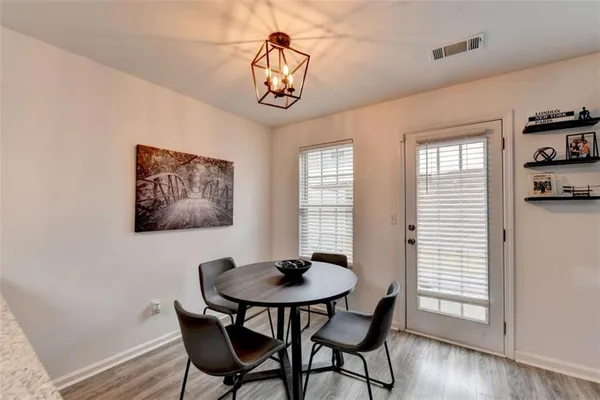 a view of a dining room with furniture window and wooden floor