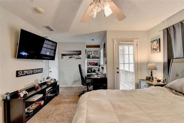 a bedroom with furniture and a flat screen tv