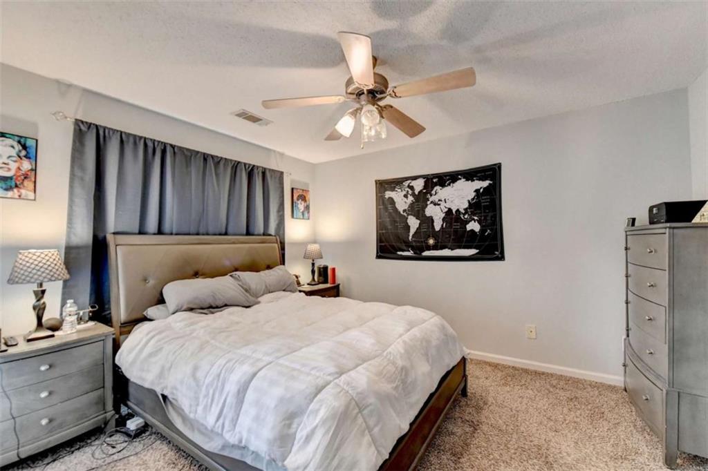 526 Terrapin Lane Winder, GA 30680 - Photo 20 of 40 a bedroom with a bed and a chandelier