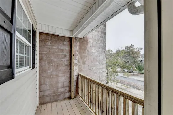 a view of a balcony with wooden floor