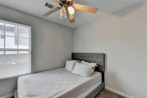 a bedroom with bed and window
