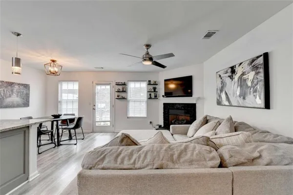 a living room with furniture fireplace and window