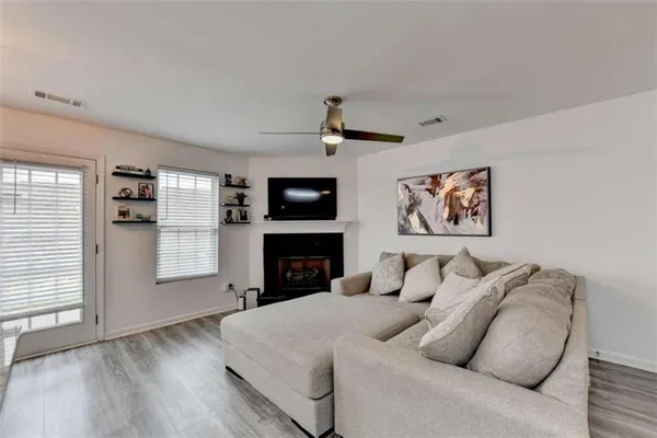 a living room with furniture and a fireplace
