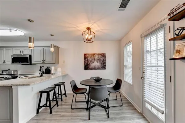 a view of a dining room with furniture window and wooden floor