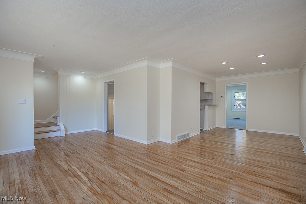 3136 Becket Road Cleveland, OH 44120 - Photo 10 of 39 Empty room with light hardwood / wood-style flooring and ornamental molding