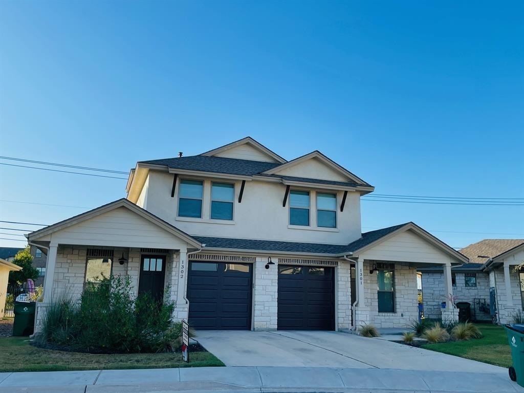 1300 Black Locust Drive West, Unit 2002 Pflugerville, TX 78660 - Photo 1 of 1 a front view of a house with yard