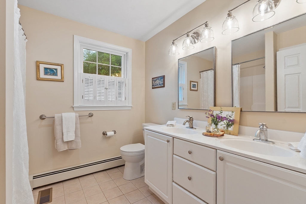86 South Cross Road Haverhill, MA 01835 - Photo 25 of 42 a bathroom with a double vanity sink a mirror and a