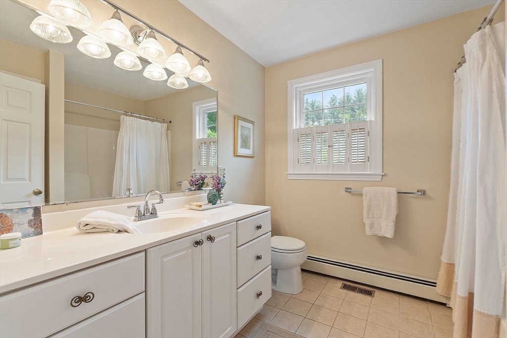 86 South Cross Road Haverhill, MA 01835 - Photo 29 of 42 a bathroom with a double vanity sink toilet and a mirror