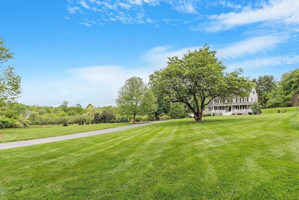 86 South Cross Road Haverhill, MA 01835 - Photo 4 of 42 a view of a big yard with a house in the background