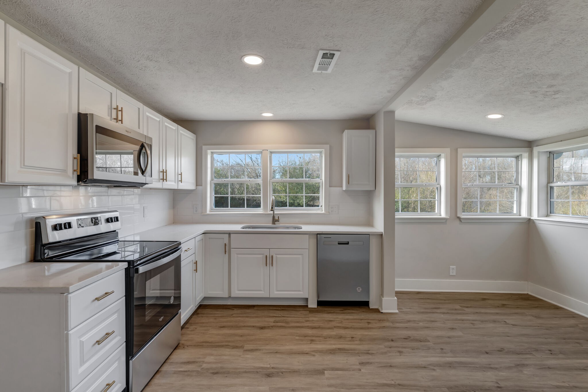 1225 Berea Church Road Lebanon, TN 37087 - Photo 6 of 26 a kitchen with stainless steel appliances granite countertop a stove a sink and a microwave