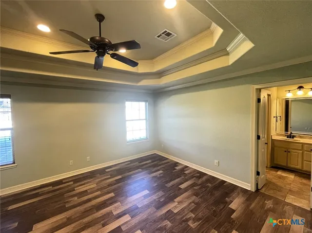 a view of a room with a window and wooden floor
