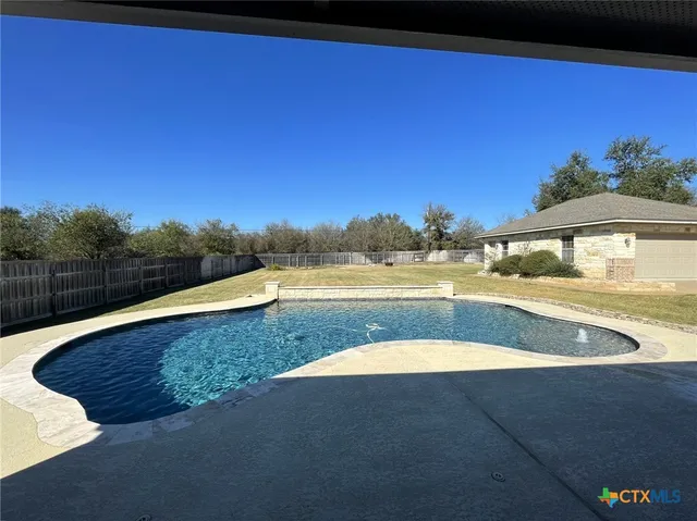 a view of swimming pool with a yard