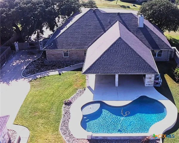 a aerial view of a house with a yard balcony and swing