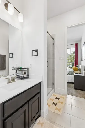 a bathroom with a tub sink and mirror