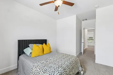 a bedroom with a bed and painting on the wall