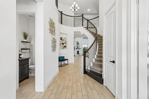 a view of entryway and hall with wooden floor