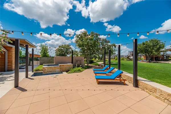a view of a chair and tables in the patio in front of a house