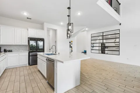 a kitchen with a sink stove and refrigerator