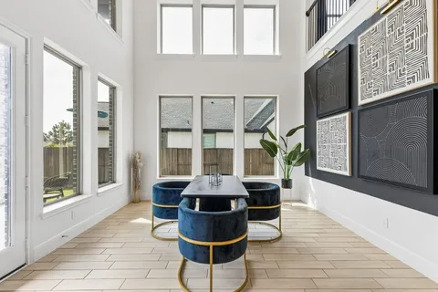a dining room with furniture and wooden floor