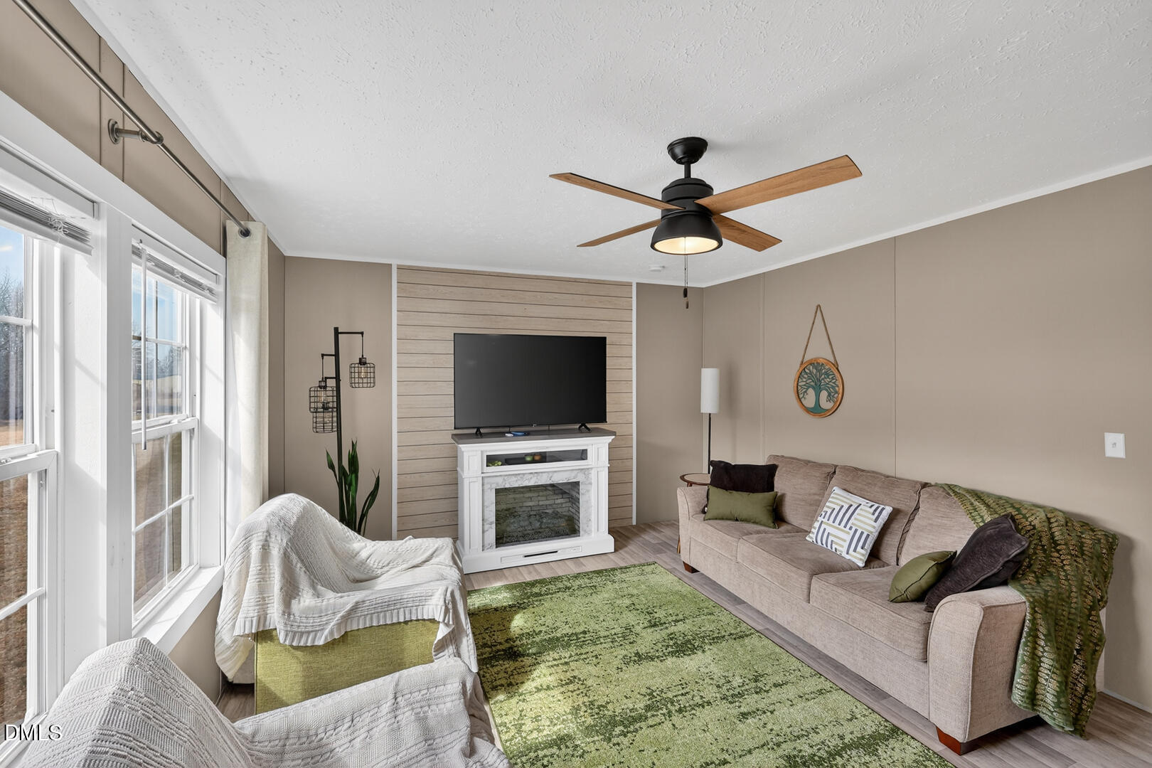 540 Pine Ridge Road Zebulon, NC 27597 - Photo 78 of 96 a living room with furniture a flat screen tv and a fireplace