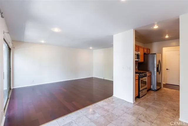 a view of a kitchen with a sink and a refrigerator